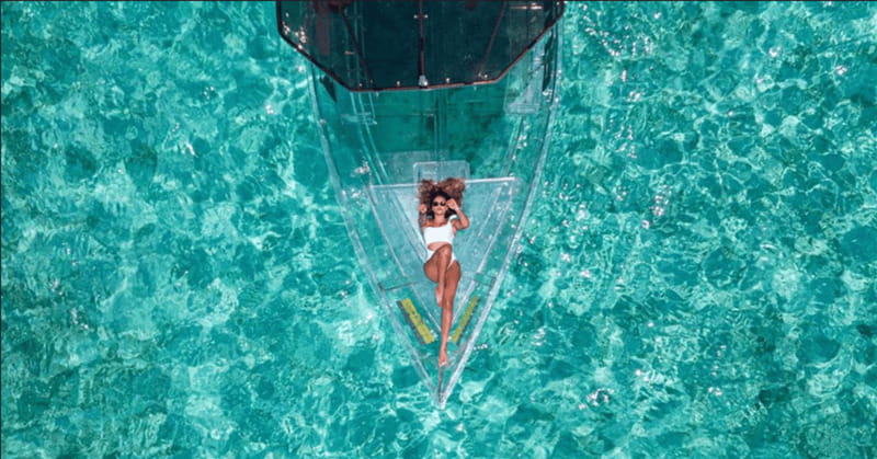 Explore the sea of cozumel in a transprent boat with drinks and snorkel. - The north side route and the San Miguel pier stop